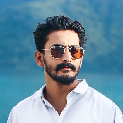 man with sunglasses on and white shirt 