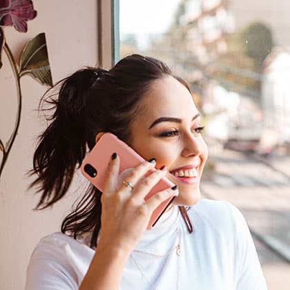 woman with a pink smartphone to ear